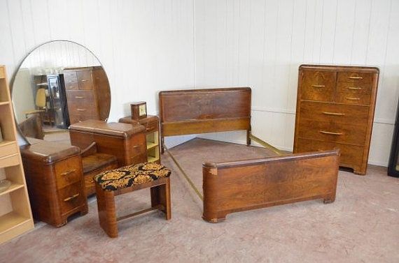 an assortment of wooden furniture in a room with carpeted flooring and white walls