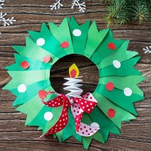 a paper wreath with a lit candle on it