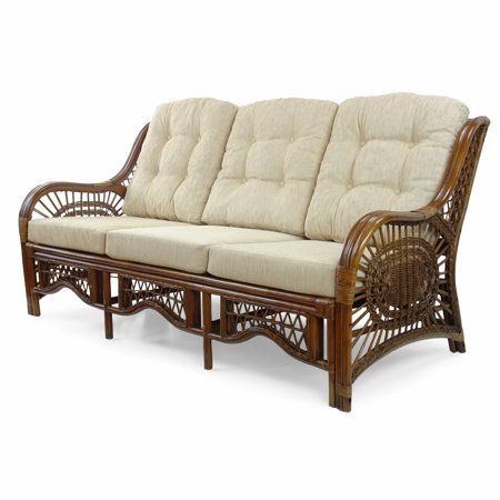 a wicker couch sitting on top of a white floor next to a wooden frame