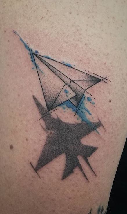 a black and white photo of an origami tattoo