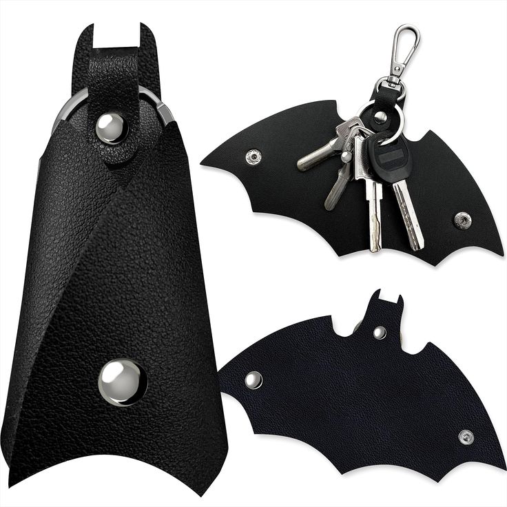 two black leather bat shaped keychains with keys in the back and one attached to it