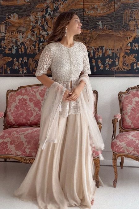 Buy Ivory Net Embroidery Thread Round Peplum Kurta Sharara Set For Women by SAISHA Online at Aza Fashions. Sharara Designs, Kurta Sharara Set, Function Dresses, Simple Lehenga, Net Embroidery, Trendy Outfits Indian, Kurta Sharara, Wedding Lehenga Designs, Lehenga Designs Simple