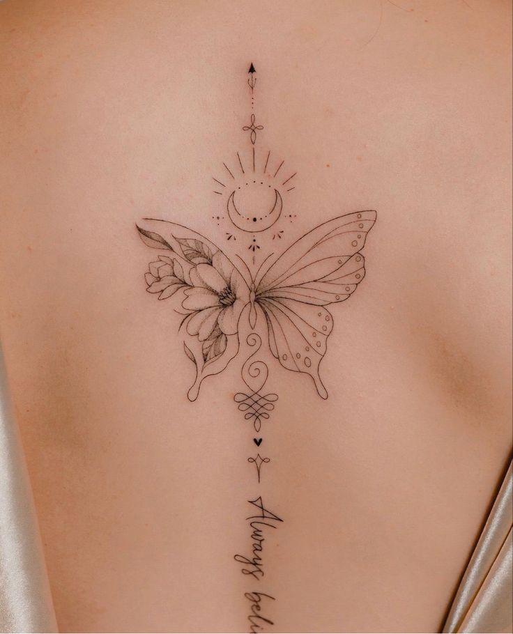 a woman's back with a butterfly tattoo on it