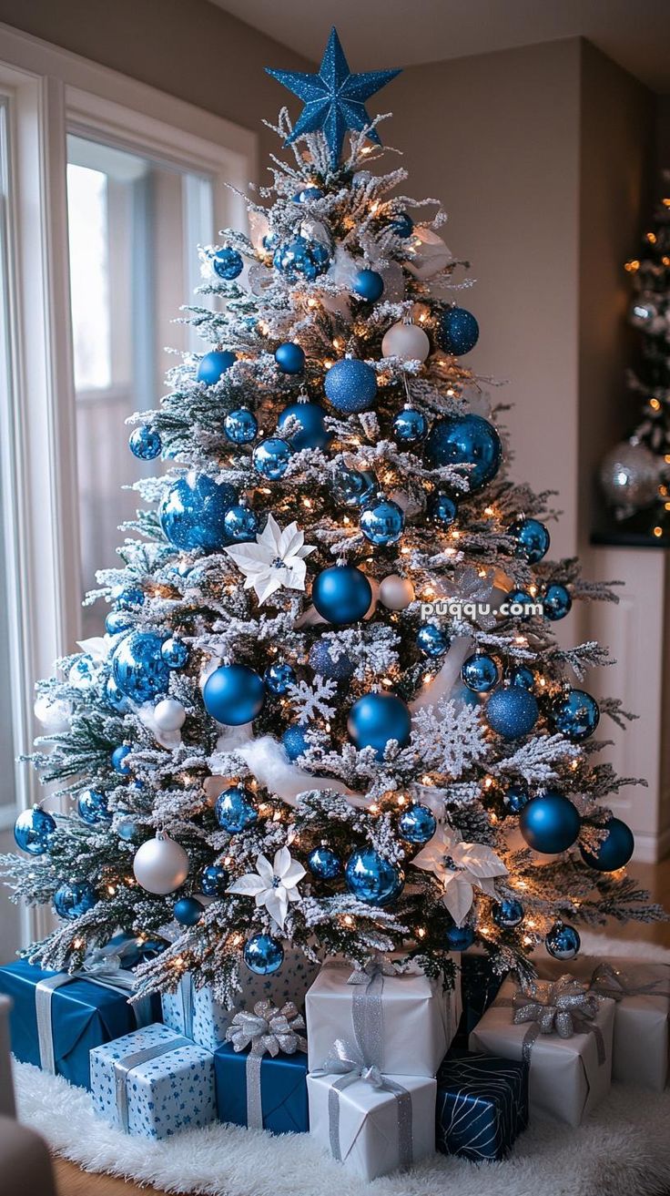 a blue and white christmas tree with presents under it