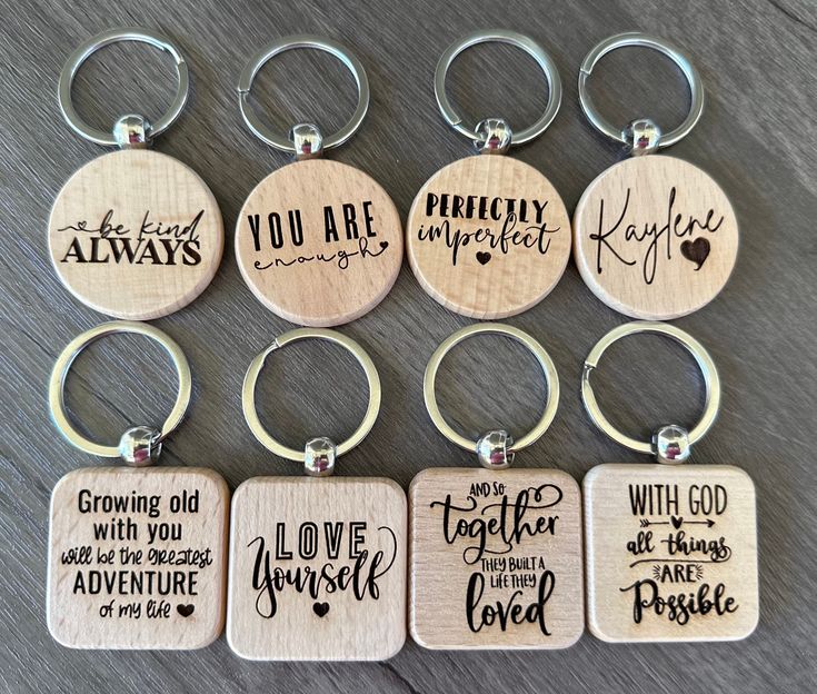 six wooden key chains with different sayings on them