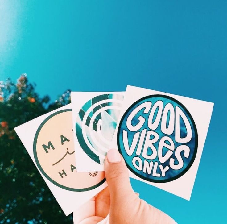 someone is holding up some stickers with the words good vibes only on them