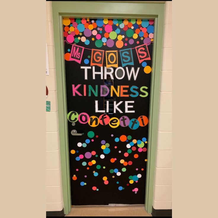 a classroom door decorated with colorful confetti and the words throw kindness like someone