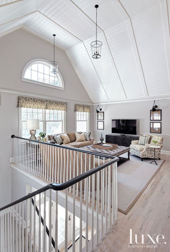 a living room filled with furniture and a fire place in the middle of an open floor plan