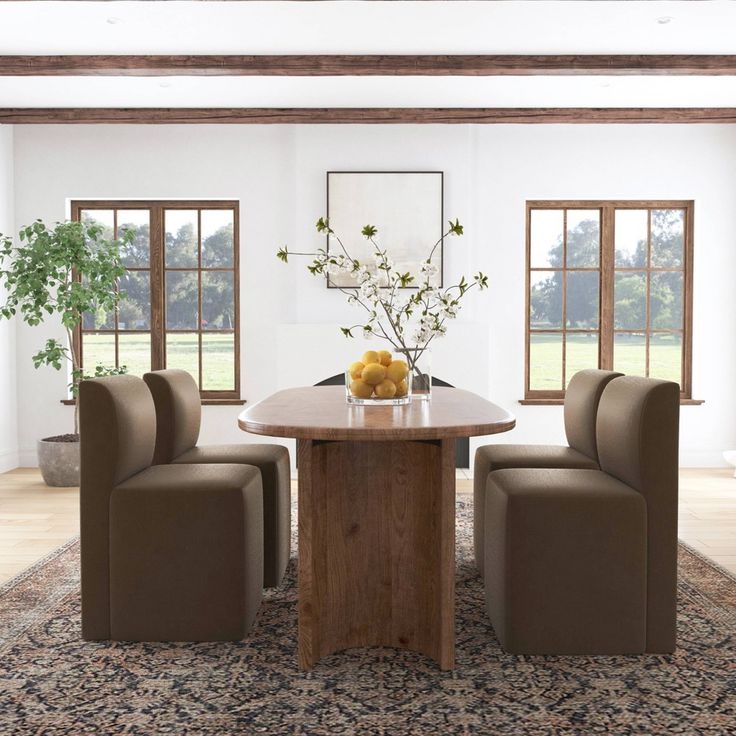 a dining room table with chairs and a vase filled with flowers on top of it