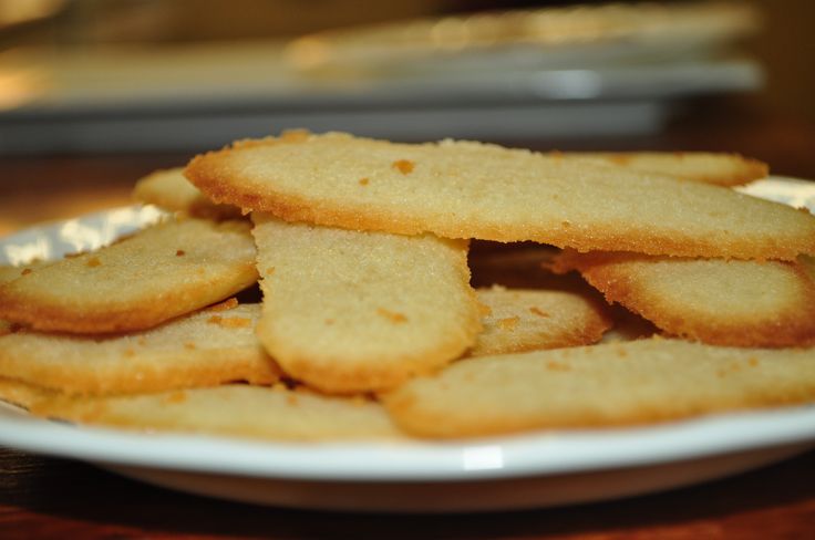 a plate full of crackers sitting on top of a wooden table