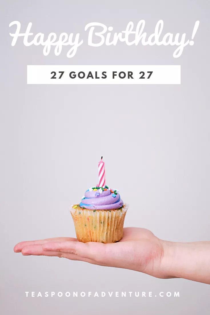 a hand holding a cupcake with a candle on it and the words happy birthday 27 goals for 27