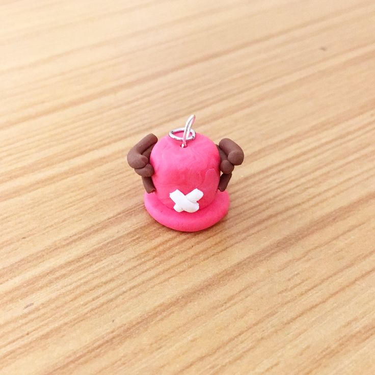 a small pink toy sitting on top of a wooden table