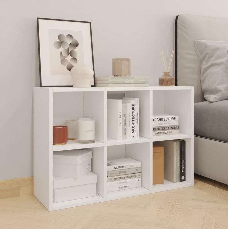 a white book shelf with books on it