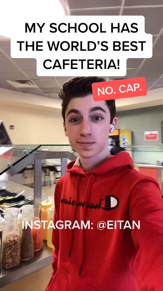 a young man wearing a red hoodie with the caption'my school has the world's best cafeteria no cap '