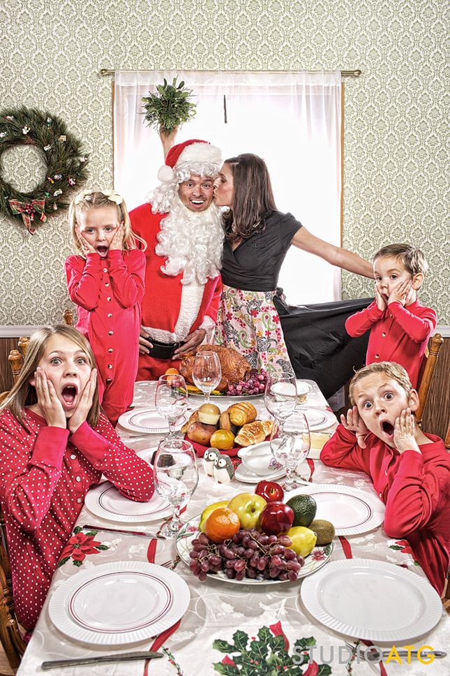 a group of children sitting around a table with santa clause on it's face