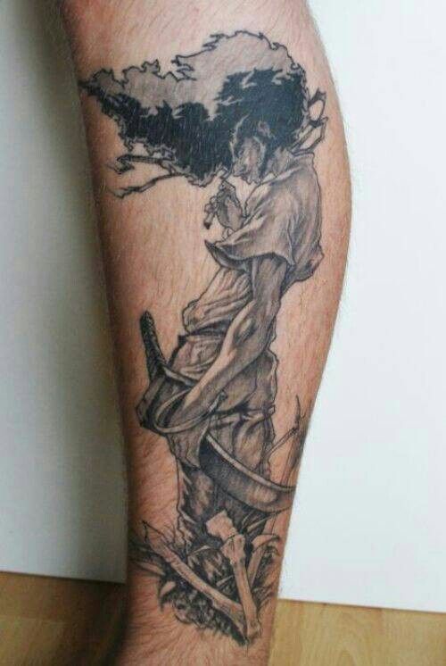 a man's leg with a tattoo on it that has an image of a person holding