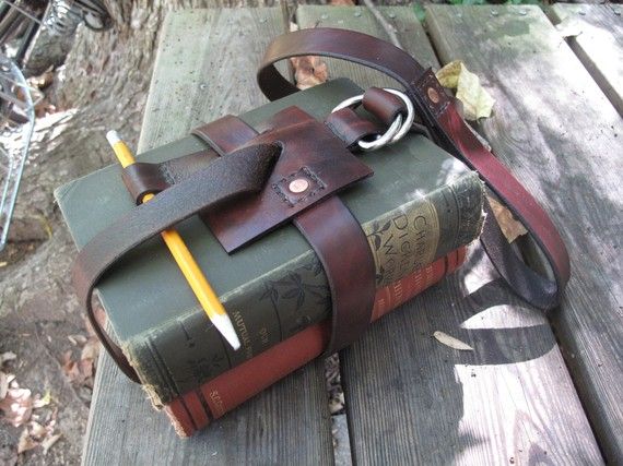 a book bag sitting on top of a wooden bench