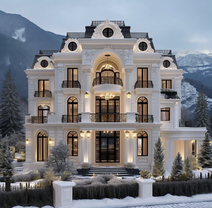 a large white building with lots of windows and balconies on the top floor