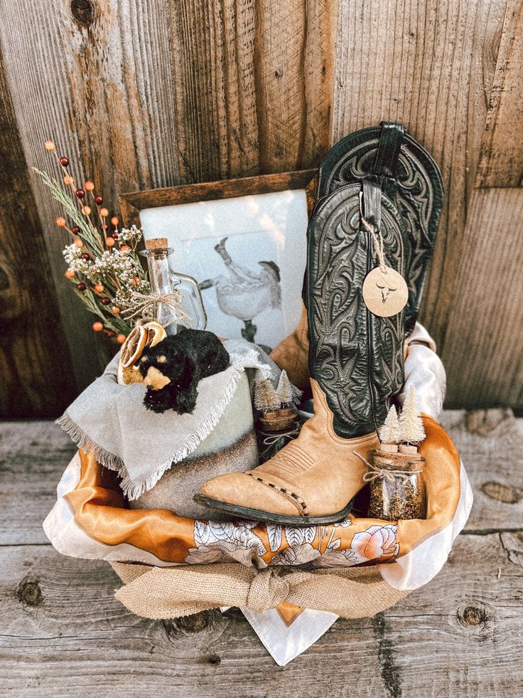 a cowboy boot and other items are sitting on a table next to a framed photograph