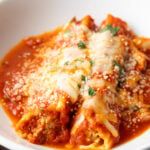 a white bowl filled with pasta and sauce