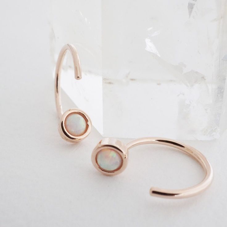 Threader hoop earrings dotted with a tiny opal. Wear these beauties solo or alongside your favorite studs or hoops. 1/2" tall. Our materials make for an amazing, high quality, seamless, jewelry piece with longevity. Our earrings are plated with 18k gold, 18k rose gold, or rhodium and finished with a protective coating. A little secret we’ll keep between us: it looks way more than it costs. Hoops Silver, Between Us, Stunning Earrings, Huggie Hoop Earrings, Accessories Jewelry Earrings, Gold Hoop, Silver Roses, Silver Rose Gold, Stone Earrings