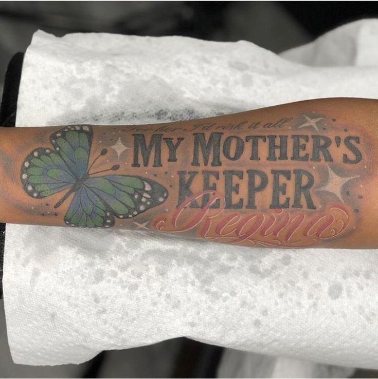 a person with a tattoo on their arm that says, my mother's keeper