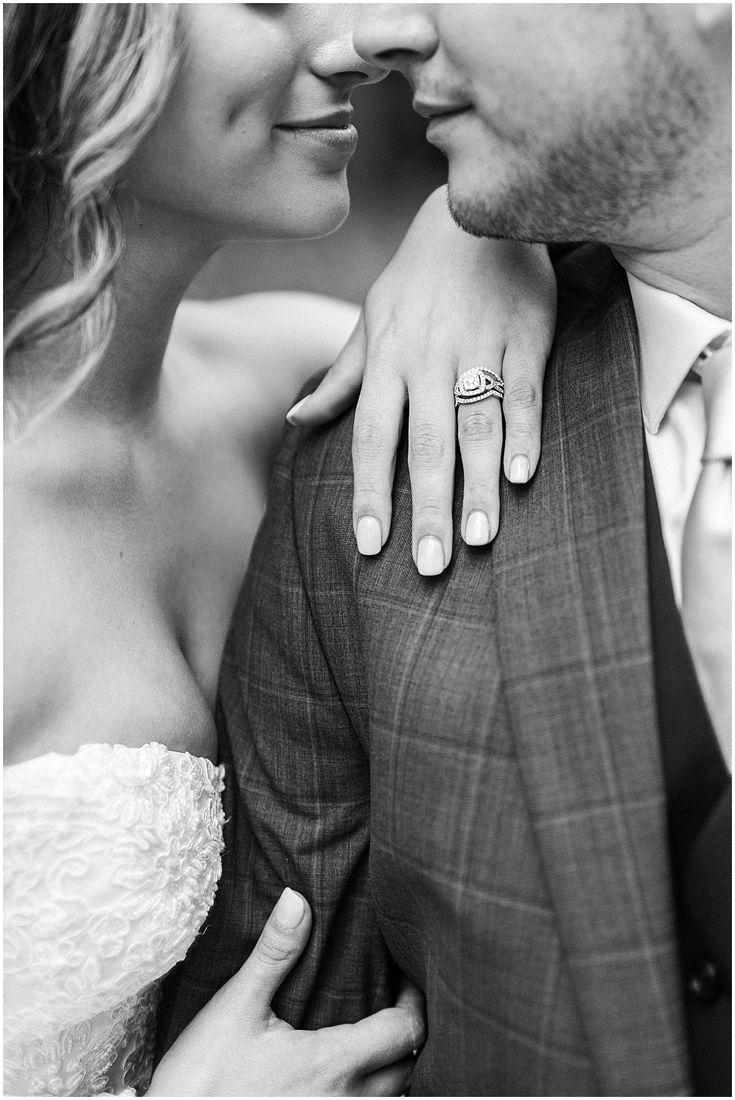 a man and woman are holding each other close together with their wedding rings on their fingers