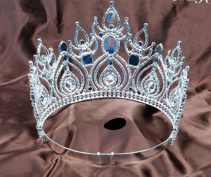 SPECIFICATIONS Spectacular large Austrian crystal tiara crown featuring a large oval crystal surrounded by fine cut teardrop pattern crystals, silver plated with a full round metal rim, slightly adjustable, clear crystal on a wide bottom crystal lined rim, color as shown. material: silver plate metal, crystal type: tiara crown color: as shown style: regal pageant center height: 5 7/8 inch/15cm diameter: 7 1/2 inch/19 cm slightly adjustable band Spoiled Princess, Teardrop Pattern, Large Crown, Pageant Hair, Crystal Tiara, Headpiece Jewelry, Stylist Tattoos, Rhinestone Crown, Tiara Crown