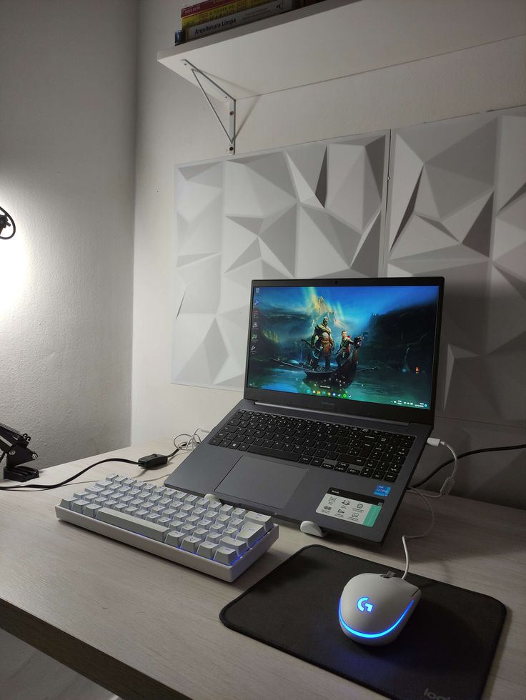 a laptop computer sitting on top of a wooden desk next to a mouse and keyboard