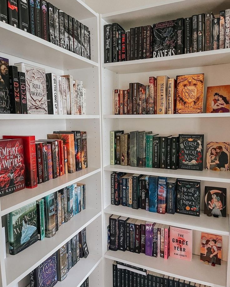 a book shelf filled with lots of books on top of white shelving unit shelves