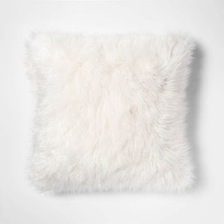 a white furry pillow on a white background