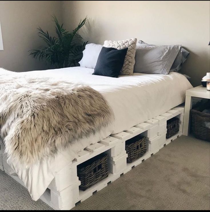 a bed made out of crates with fur on top