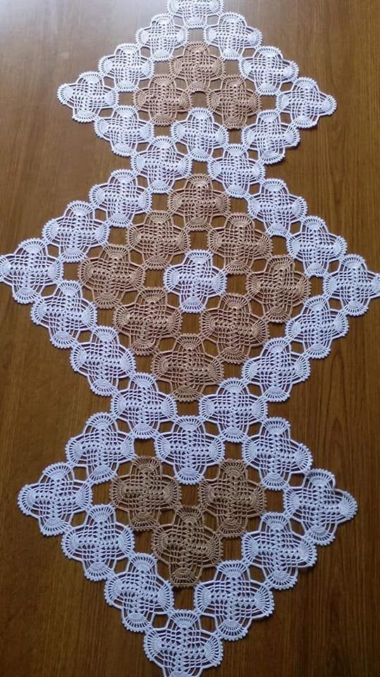 three pieces of crocheted doily sitting on top of a wooden table