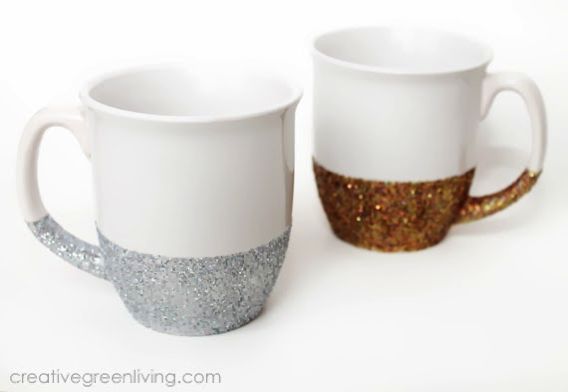 two white and gold coffee mugs sitting next to each other on a white surface