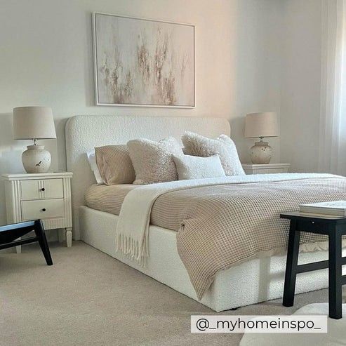 a bedroom with white furniture and neutral colors