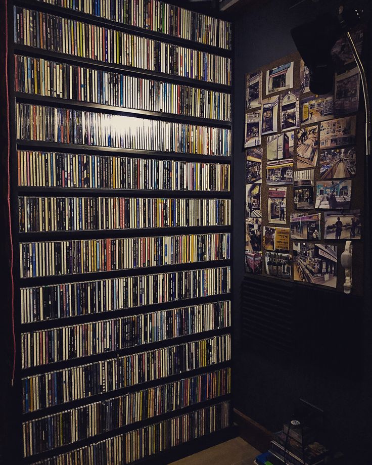 a wall full of dvds in a room