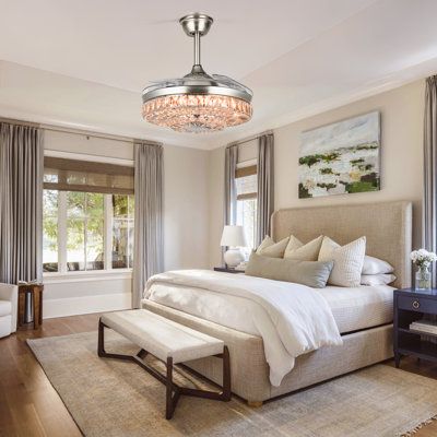 a bedroom with a large bed and chandelier hanging from it's ceiling