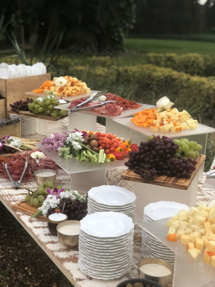 a table topped with lots of plates and bowls filled with different types of food on top of it