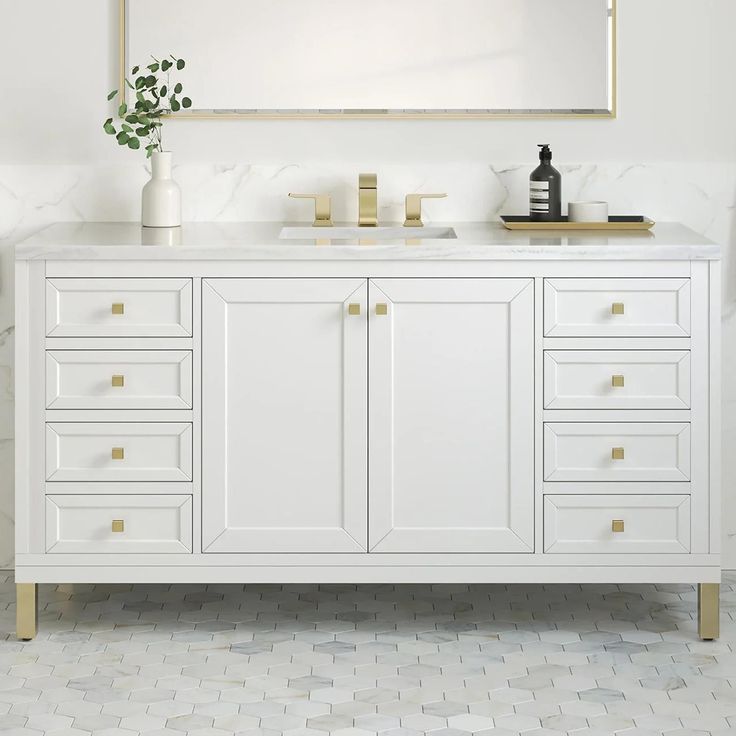 a white bathroom vanity with gold handles and drawers