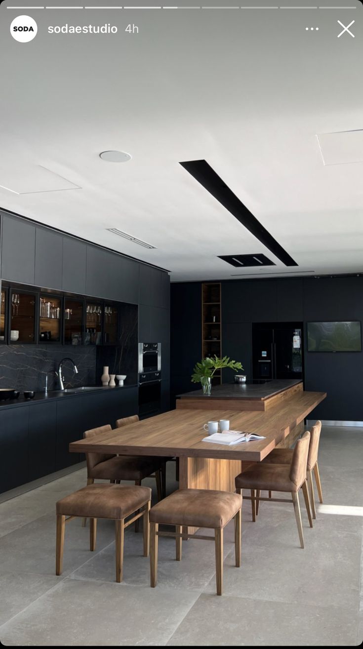 a large wooden table sitting in the middle of a kitchen