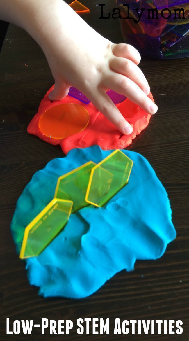 a child's hand on top of a paper plate