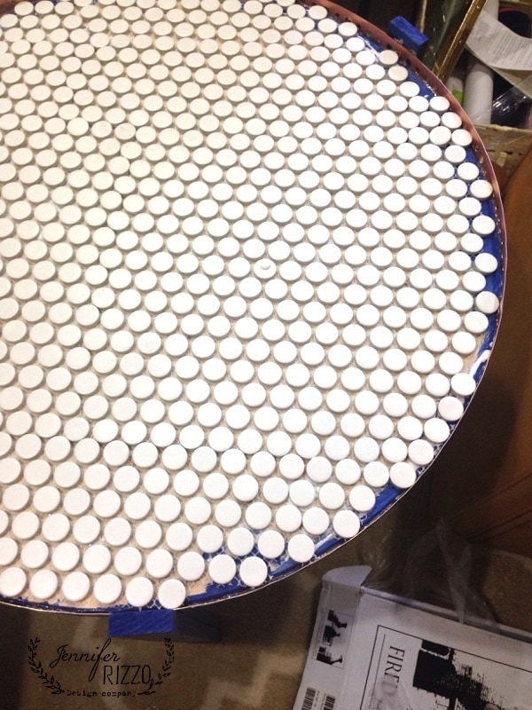 a table that has some white cups on it and is sitting next to a pile of papers