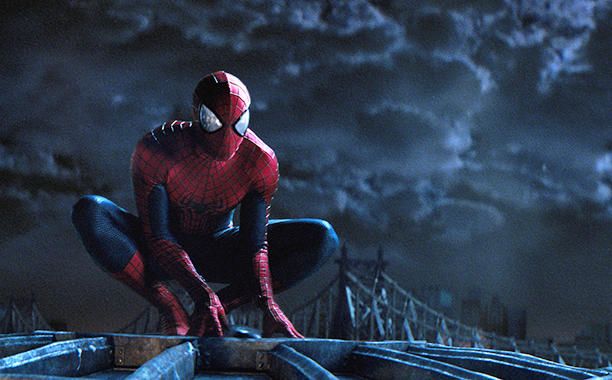 the amazing spider - man stands on his knees in front of dark clouds