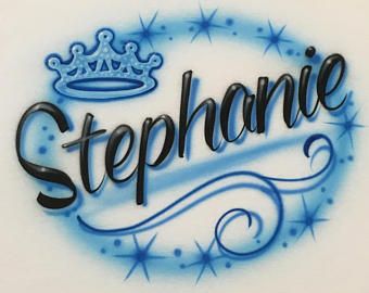 a white shirt with blue lettering and a crown on the front that says, stephanie