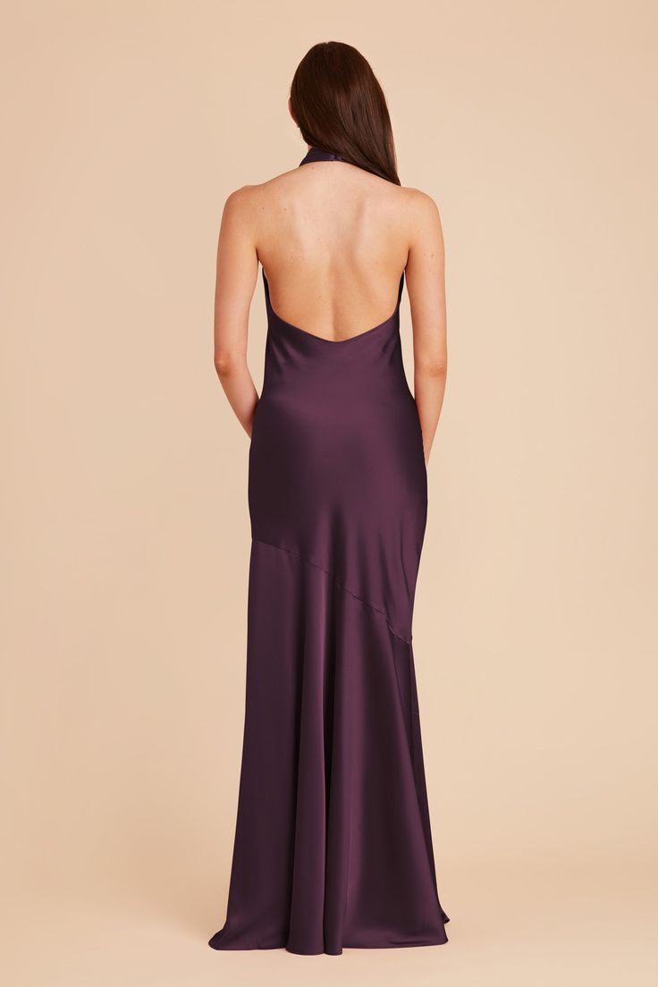 the back of a woman in a purple dress, with her back turned to the camera