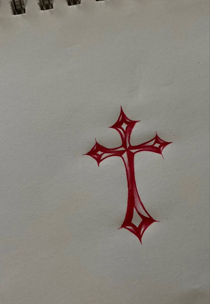 a red cross drawn on top of a piece of paper