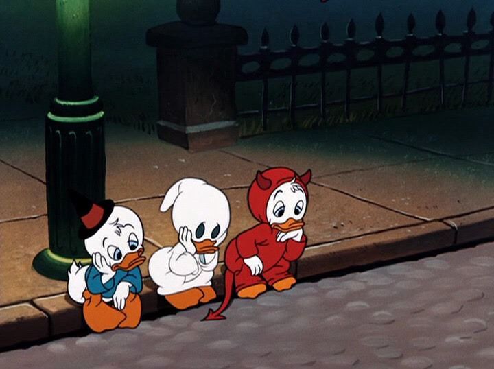 three cartoon characters sitting on the ground in front of a lamp post and fenced area