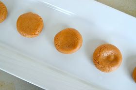 four peanut butter cookies sitting on top of a white plate