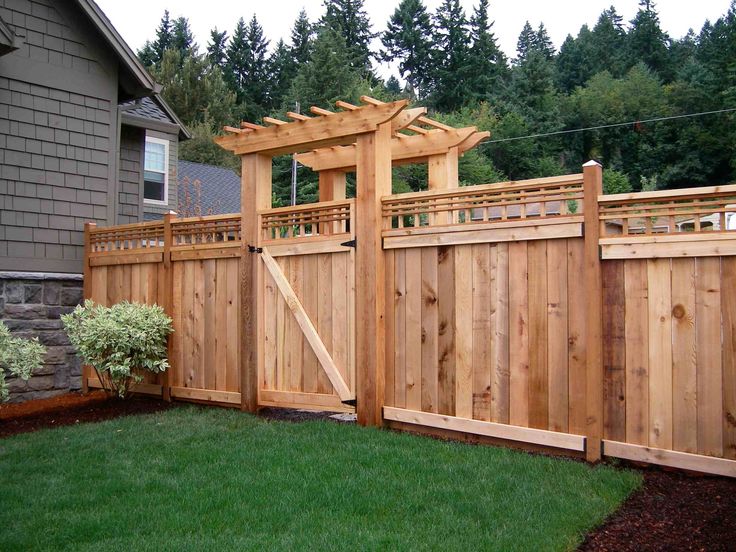 a wooden fence in front of a house