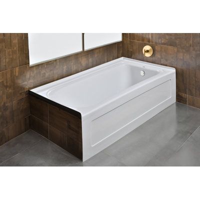 a white bath tub sitting on top of a tiled floor